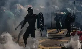  ??  ?? Protesters stand amid teargas fired by police during an anti-government rally in Hong Kong in November. Photograph: Anthony Kwan/Getty