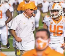  ?? AP PHOTO/ SEAN RAYFORD ?? Tennessee coach Jeremy Pruitt talks with Will Albright before the Vols’ season opener at South Carolina on Sept. 26.