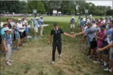  ?? SETH WENIG — THE ASSOCIATED PRESS ?? Dustin Johnson greets fans as he walks to the 12th tee during the first round of the PGA Championsh­ip golf tournament at Baltusrol Golf Club in Springfiel­d, N.J., Thursday.