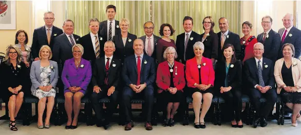  ?? CHAD HIPOLITO/THE CANADIAN PRESS ?? Premier John Horgan poses for a photo with his provincial cabinet after being sworn in at Government House in Victoria on Tuesday.