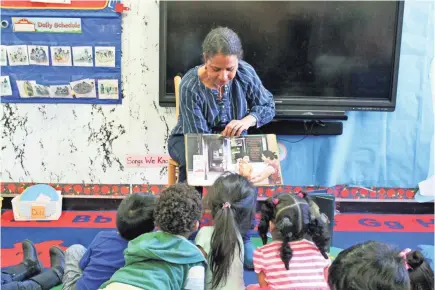  ?? ADRIANA ALBA/CHILDREN’S AID ?? In this 2018 photo, Nina Crews, illustrato­r of “A Girl Like Me,” reads to children at an early childhood education center. Crews said the work of independen­t publishers and grassroots organizers are vital in bringing more racial diversity into children’s books.