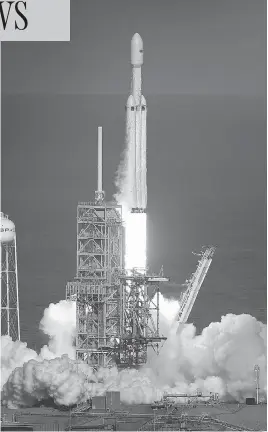  ?? JOE RAEDLE / GETTY IMAGES ?? The SpaceX Falcon Heavy rocket lifts off from launch pad 39A at Kennedy Space Center on Tuesday. The rocket carried SpaceX founder Elon Musk’s Tesla Roadster into orbit.