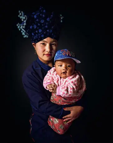  ??  ?? Above: Here, in terms of fashion, tradition meets the modern day: a woman with her child, of the Tibeto-Burman Lisu ethnic group, who reside in southwest China.