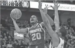  ?? AP ?? The Suns’ Josh Jackson (20) attempts a layup vs. Jazz forward Derrick Favors on Wednesday in Salt Lake City.