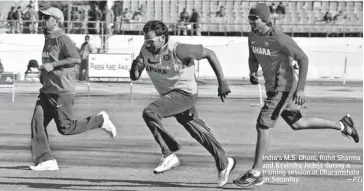  ??  ?? India’s M. S. Dhoni, Rohit Sharma and Ravindra Jadeja during a training session in Dharamshal­a on Saturday.