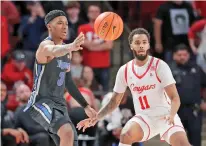  ?? MICHAEL WYKE/ASSOCIATED PRESS FILE PHOTO ?? Memphis guard Landers Nolley II, left, passes the ball in front of Houston guard Kyler Edwards during a Feb. 12 game in Houston.