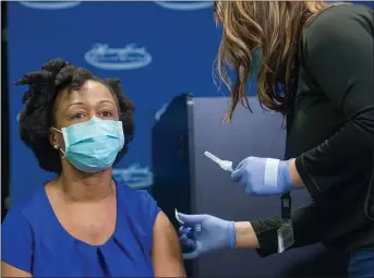  ?? COURTESY MDHHS ?? Dr. Joneigh Khaldun, MDHHS chief medical executive and emergency medicine physician at Henry Ford Hospital, receives her COVID-19 vaccine during an event at Henry Ford Hospital in Detroit on Thursday, Dec. 17, 2020.