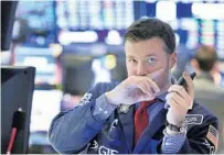  ?? RICHARD DREW/AP ?? Trader Frank Masiello works the floor of the New York Stock Exchange on Friday as stocks rallied late in the session.