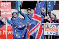  ?? AFP ?? Anti-Brexit supporters hold placards and flags as they demonstrat­e outside the Houses of Parliament on Monday. —