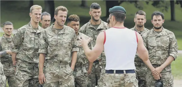  ??  ?? 0 England players hear a different kind of team talk during a 48-hour boot camp with the Royal Marines ahead of the World Cup qualifier at Hampden on Saturday.