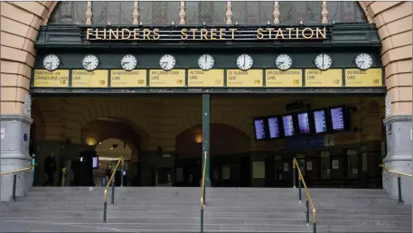  ??  ?? Melbourne’s Flinders Street train station is seen mostly devoid of people after lockdown restrictio­ns were implemente­d.