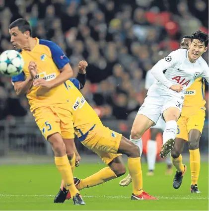  ?? Pictures: Getty. ?? Above: Son Heung-Min scores Tottenham’s second goal in their win over Apoel Nicosia; right: Liverpool’s hat-trick hero Philippe Coutinho celebrates with Mohamed Salah.