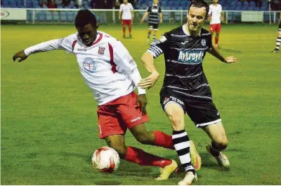  ??  ?? Bangor’s Christian Langos (white shirt) takes on Bala Town’s Conall Murtagh. Pic: Naomi Jones