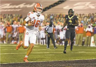  ?? Walt Unks / Winston-Salem Journal ?? Clemson quarterbac­k Trevor Lawrence scores against Wake Forest in the Tigers’ 3713 rout.