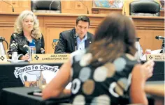  ?? LUIS SÁNCHEZ SATURNO/THE NEW MEXICAN ?? County commission­er Anna Hansen and Mayor Javier Gonzales listen to County Manager Katherine Miller during a County Commission and City Council joint meeting Thursday to discuss the county’s proposed gross receipts tax increase.