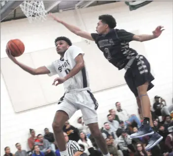  ?? Photos by Ernest A. Brown ?? TOP, St. Raphael senior Huascar Beato (4) sails to the hoop for two points in front of Shea sophomore Erickson Bans during the first half of boys’ final of the DonaldsonL­ynch Memorial Tournament at the Boys and Girls Club of Pawtucket on Saturday...