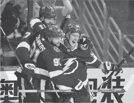  ?? MIKE CARLSON/GETTY IMAGES ?? Victor Hedman, rear, and Steven Stamkos (seen with Ondrej Palat) have been chasing a Stanley Cup for almost a decade with the Tampa Bay Lightning.