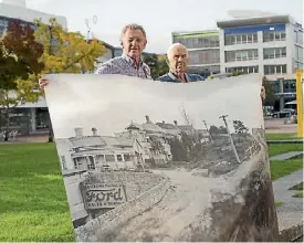  ??  ?? One Hill of a Fight, written and directed by Michael Switzer, Meteor Theatre. Russell Armitage and Graham Baird hold a picture of Garden place when there was a hill on it.