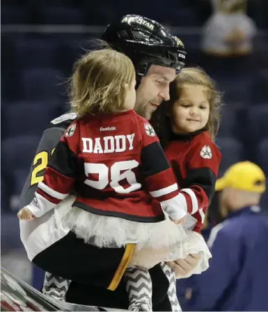  ?? MARK HUMPHREY/THE ASSOCIATED PRESS ?? John Scott shares a moment with his two children after being named MVP of Sunday’s all-star game in Nashville.