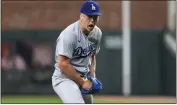  ?? JASON GETZ – ATLANTA JOURNAL-CONSTITUTI­ON VIA AP ?? Dodgers rookie pitcher Bobby Miller is fired up after striking out the Braves’ Matt Olson to end the fifth inning Monday.