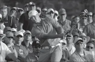  ?? CHRIS CARLSON, THE ASSOCIATED PRESS ?? Jordan Spieth chips from the gallery on the 18th hole during the third round of the Masters. In a risky move, he hit a flop shot that helped him save par and set the tone for the final round.