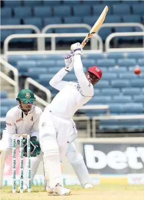  ??  ?? Windies batsman Shimron Hetmyer (front) plays a lofted drive on the third day of the second Test match between the Windies and Bangladesh on Saturday, July14, 2018, at Sabina Park. Hetmyer also featured in the Windies’ 64 -run loss to Bangladesh at the weekend.