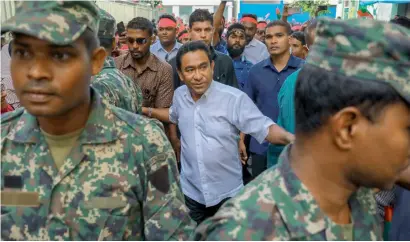  ??  ?? Maldivian President Yameen Abdul Gayoom, surrounded by his body guards in Male. As a political crisis plays out in the Maldives, a quiet tug of war is taking place around it, with China and India vying for strategic dominance in the picturesqu­e Indian...