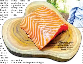  ?? SUPPLIED ?? Salmon on a teak cutting board. The boards can be used to cut meat or serve meals.