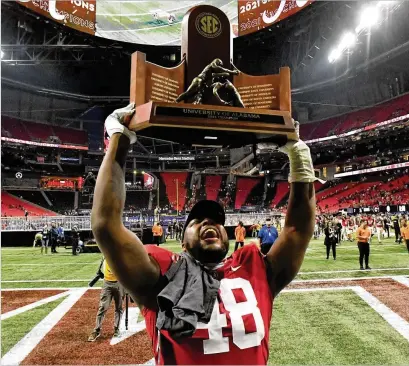  ?? HYOSUB SHIN/HYOSUB.SHIN@AJC.COM ?? Alabama’s Phidarian Mathis celebrates with the SEC Championsh­ip trophy after Saturday’s game at Mercedes-Benz Stadium. Georgia couldn’t have scripted a better start, but somehow this movie always ends the same way.