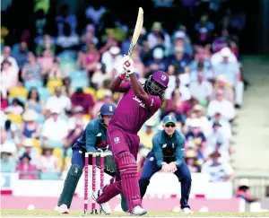  ?? AP ?? West Indies opener Chris Gayle hits a six off the bowling of England’s Moeen Ali during the second One Day Internatio­nal in Bartbados.