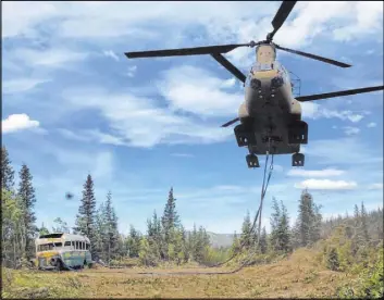  ?? The Associated Press ?? In a photo released by the Alaska National Guard, soldiers use a CH-47 Chinook helicopter to remove an abandoned bus, popularize­d by the book and movie “Into the Wild,” from its location in the Alaska backcountr­y Thursday.