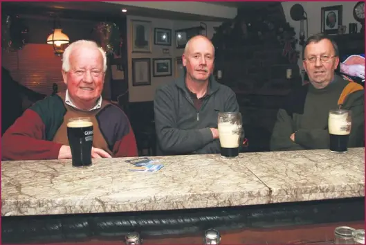  ?? Photos by John Reidy ?? Proprietor Alan Kennelly (left) pictured with: Jerh Shanahan and Jackie Walsh in the Ballylongf­ord corner-house bar last week.