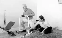  ?? JACOB LANGSTON/STAFF PHOTOGRAPH­ER ?? Elina Nubaryan, right, works with Kent Weisner at The Stretching Room in College Park.