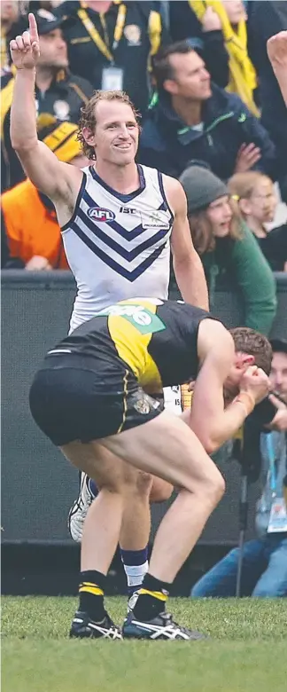  ??  ?? David Mundy celebrates his winning goal for Fremantle against Richmond. Picture: WAYNE LUDBEY SHAYNE HOPE