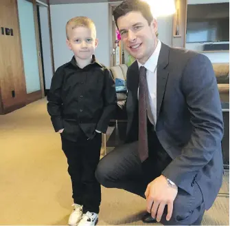  ??  ?? Sidney Crosby with five-year-old Memphis Savage, who was diagnosed with a brain tumour at 15 months.