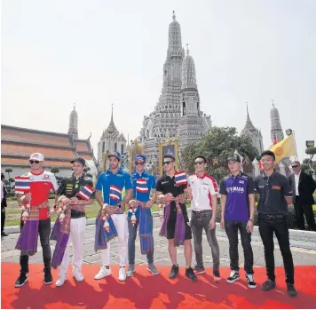  ?? PAWAT LAOPAISARN­TAKSIN ?? ABOVE MotoGP riders visit Bangkok’s Temple of Dawn yesterday ahead of a test in Buri Ram this weekend.