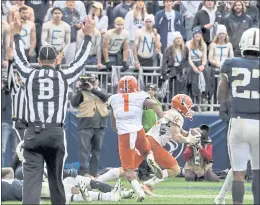  ?? BARRY REEGER — THE ASSOCIATED PRESS ?? Illinois wide receiver Casey Washington, center, catches the winning 2-point conversion during the ninth overtime of Saturday’s Big Ten game against seventh-ranked Penn State.