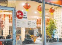  ?? Frank Franklin II The Associated Press ?? People eat inside the New Shanghai Deluxe restaurant as indoor dining resumed Feb. 12 in the Chinatown neighborho­od of New York.