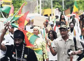  ?? FILE ?? Members of the Rastafaria­n community march in the downtown Kingston area to commemorat­e the 50th anniversar­y of the infamous Coral Gardens incident of 1963 in March 2013.