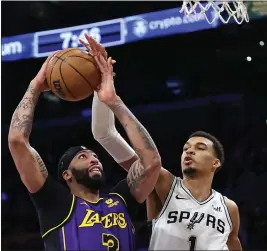  ?? SEAN M. HAFFEY — GETTY IMAGES ?? The Spurs' Victor Wembanyama (1) blocks a shot by the Lakers' Anthony Davis during the first half of Friday night's game. Davis scored 28points and Wembanyama had 27.