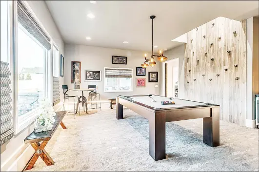  ??  ?? This undated photo provided by the Central Oklahoma Home Builders Associatio­n and Authentic Custom Homes shows part of a recreation room in a luxury home in Oklahoma. (AP)