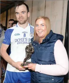  ??  ?? Knocknagre­e captain Danny Cooper receives the man of the match award from Mary O’Sullivan, Kanturk Credit Union.