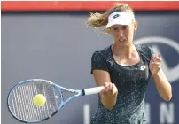  ??  ?? Belgium’s Elise Mertens hits a return against Canada’s Eugenie Bouchard during day two of the Rogers Cup. —