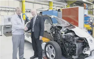  ??  ?? Kevin Fitzpatric­k, Nissan Europe divisional vice president for manufactur­ing and Councillor Harry Trueman, leader of Sunderland City Council, with the Nissan half-LEAF