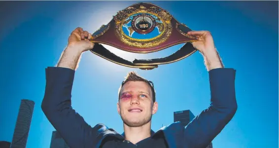  ?? Picture: PATRICK HAMILTON /AFP ?? Newly crowned World Boxing Organisati­on welterweig­ht champion Jeff Horn poses for photograph­s with his belt in Brisbane yesterday.