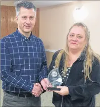  ?? SUBMITTED ?? Mark Victor, president of Winsloe-Charlottet­own Royals F.C. club, presents Juanita Diamond with the Alan Godfrey volunteer of the year award.
