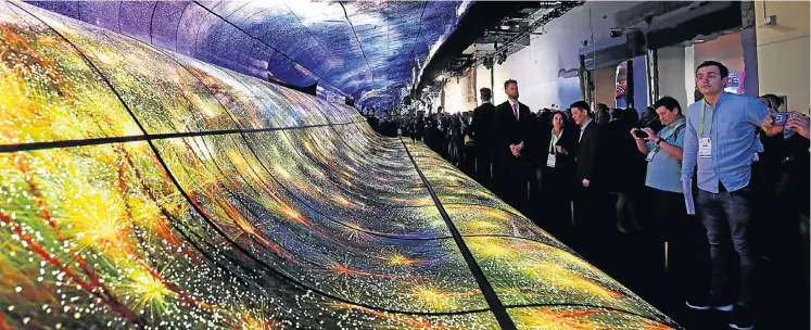  ?? Picture: Reuters/Steve Marcus ?? Attendees watch a display made up of curved OLED television screens at the LG Electronic­s booth during the 2019 CES in Las Vegas this week.