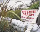  ?? Brian A. Pounds / Hearst Connecticu­t Media ?? Sandbags provide protection against heavy surf in Fairfield on Aug. 4.