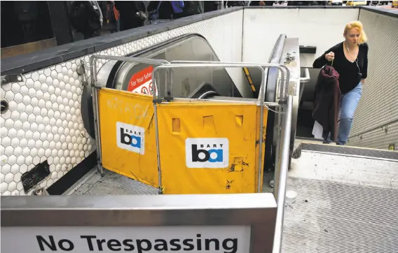  ?? Michael Macor / The Chronicle ?? One of the escalators at the Powell Street BART Station is under repair. Exposed to weather and all manner of untoward usage — why did it break down?