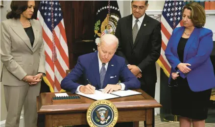  ?? ALEX WONG/GETTY ?? President Biden signs an executive order on Friday to protect abortion access. Looking on are Vice President Kamala Harris, left, Secretary of Health and Human Services Xavier Becerra and Deputy Attorney General Lisa Monaco.